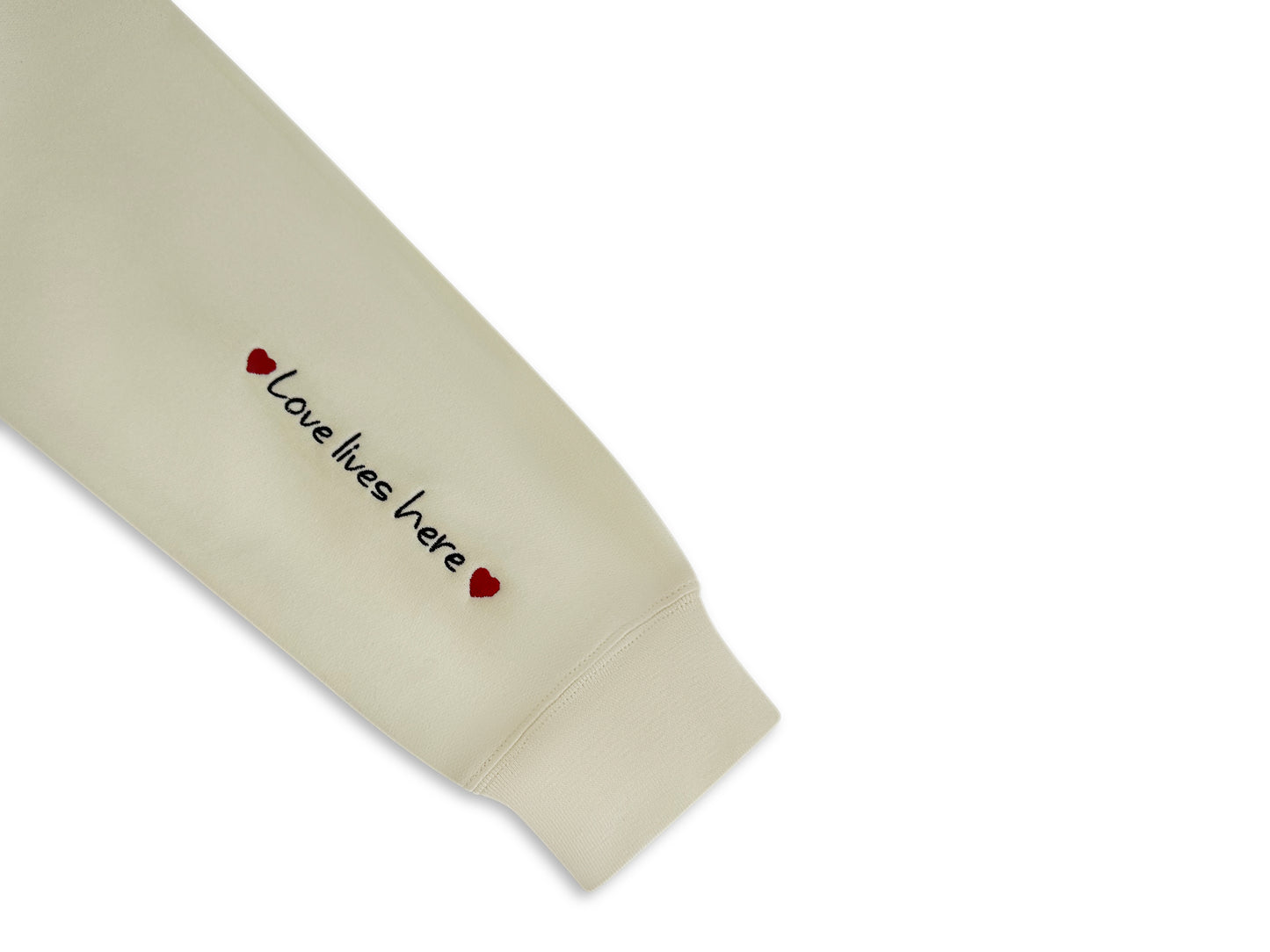 Beige sleeve with 'Love lives here' text and heart symbols on a white background. custom-branded embroidery
no minimum order embroidery
free logo setup apparel
personalized business embroidery
family-owned custom embroidery shop