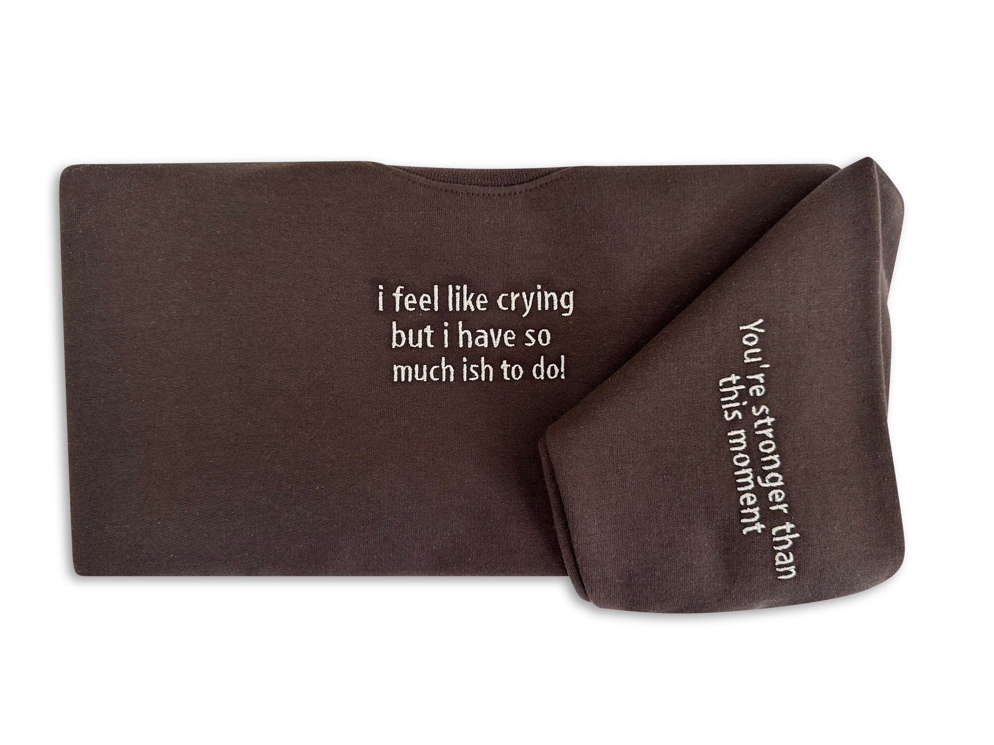 Brown fabric with printed text on a white background. handcrafted embroidered apparel
cozy embroidered crewnecks
unique embroidered accessories
bookish embroidery designs
pet-themed embroidered tees
made-to-order embroidered gifts