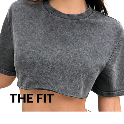 Gray crop top worn by a person with 'THE FIT' text on a white background