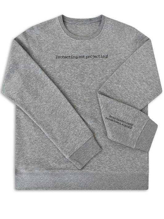 Gray sweatshirt with text on a white background. logo embroidery for businesses