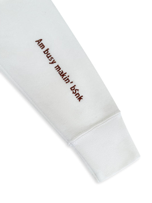 White sweatshirt with text 'Am busy makin' b$nk' on a white background. custom-branded embroidery
no minimum order embroidery
free logo setup apparel
personalized business embroidery
family-owned custom embroidery shop