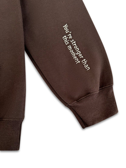 Brown sweatshirt sleeve with motivational text on a white background. handcrafted embroidered apparel
cozy embroidered crewnecks
unique embroidered accessories
bookish embroidery designs
pet-themed embroidered tees
made-to-order embroidered gifts